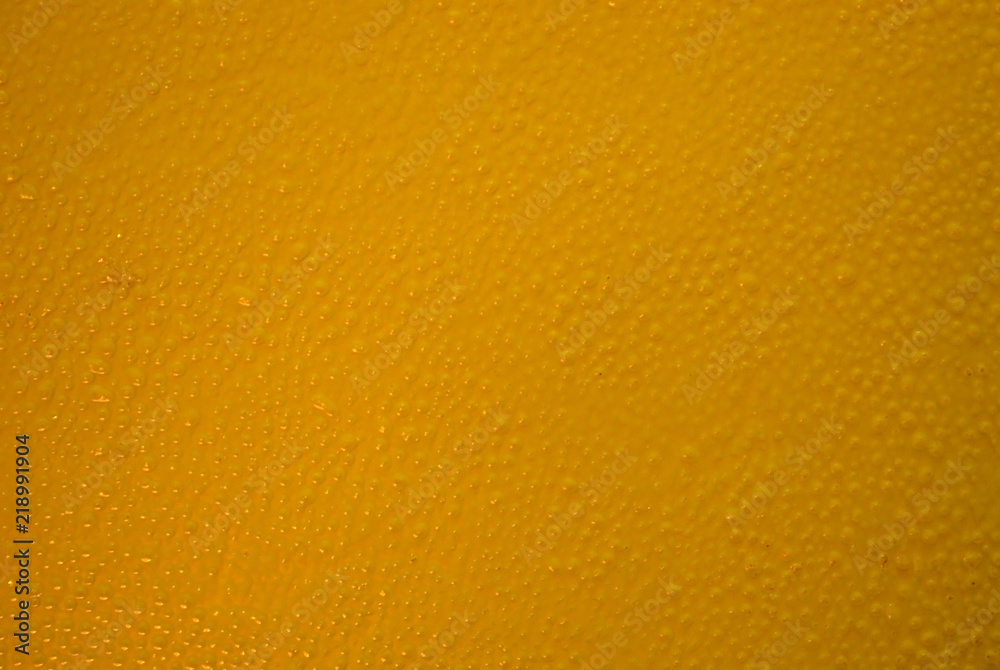 A dark yellow background painted with acrylic paints on glass A dark yellow background painted with acrylic paints on glass