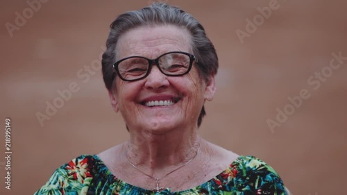 Smiling elderly woman looking at camera photo