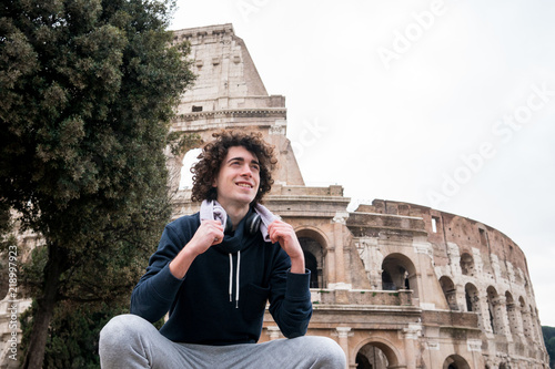 Photography Handsome young sportsman relaxing after training with a towel around his neck in
