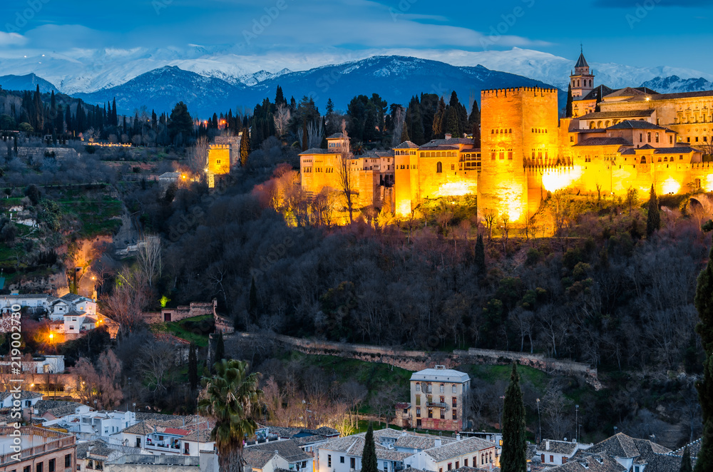 Night cityscape of Granada, Spain, with the Alhambra Palace in the background