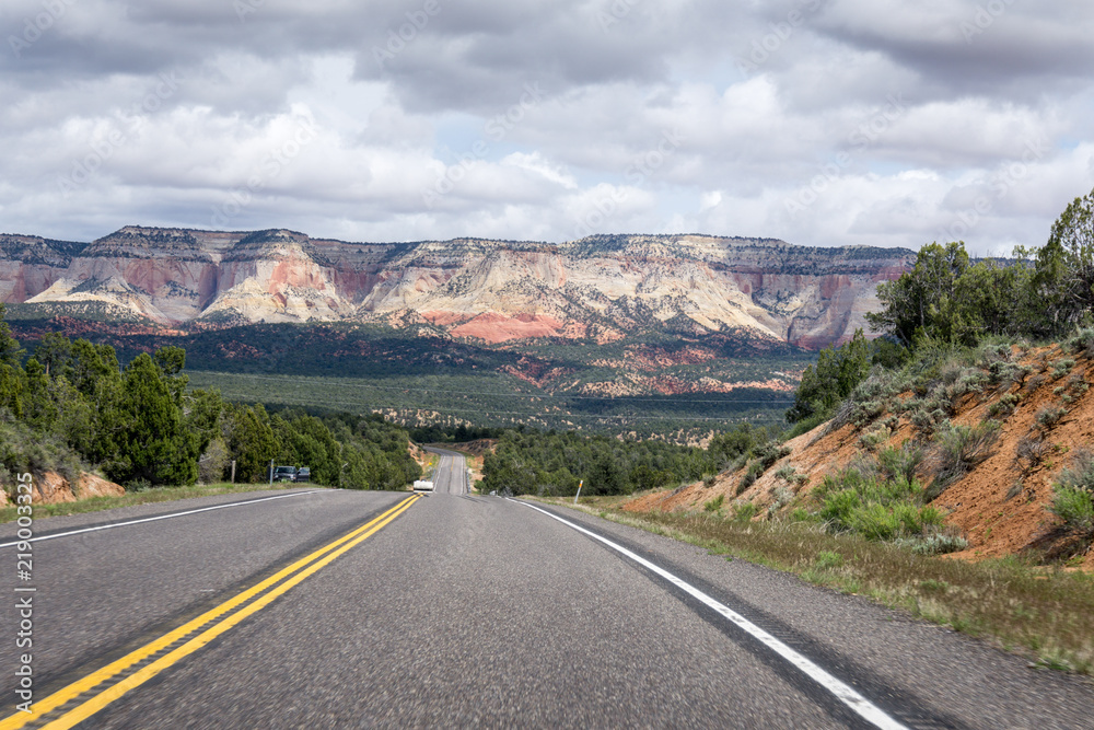 Empty road in front of a mountain in Zion National Park, utah, USA