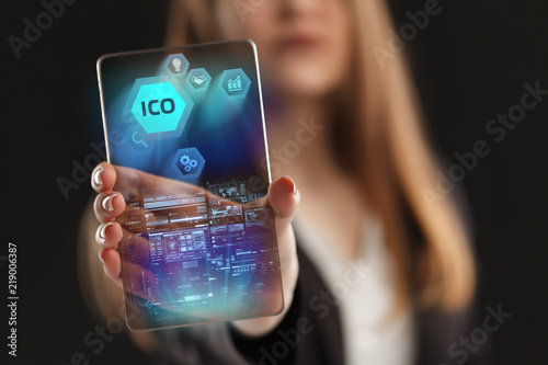 The concept of business, technology, the Internet and the network. A young entrepreneur working on a virtual screen of the future and sees the inscription: ICO photo