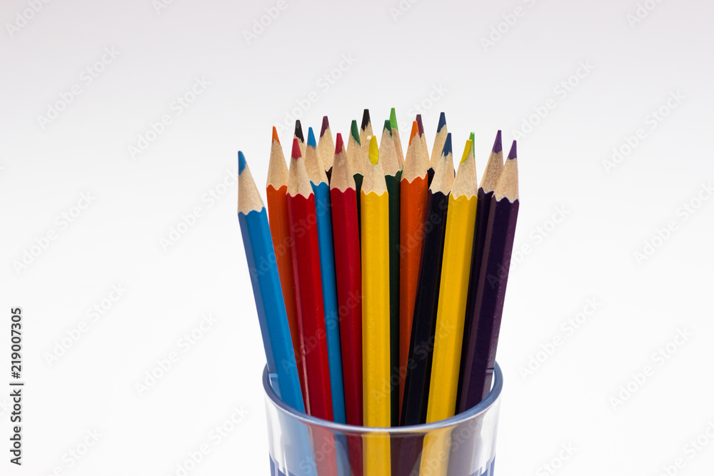 colored pencils in a glass isolated on business background colored pencils in a glass isolated on business background