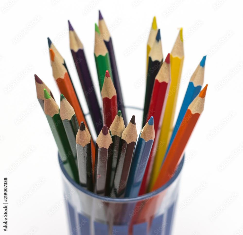 colored pencils in a glass isolated on business background colored pencils in a glass isolated on business background