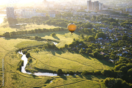 Balloon at dawn flies over the river photo