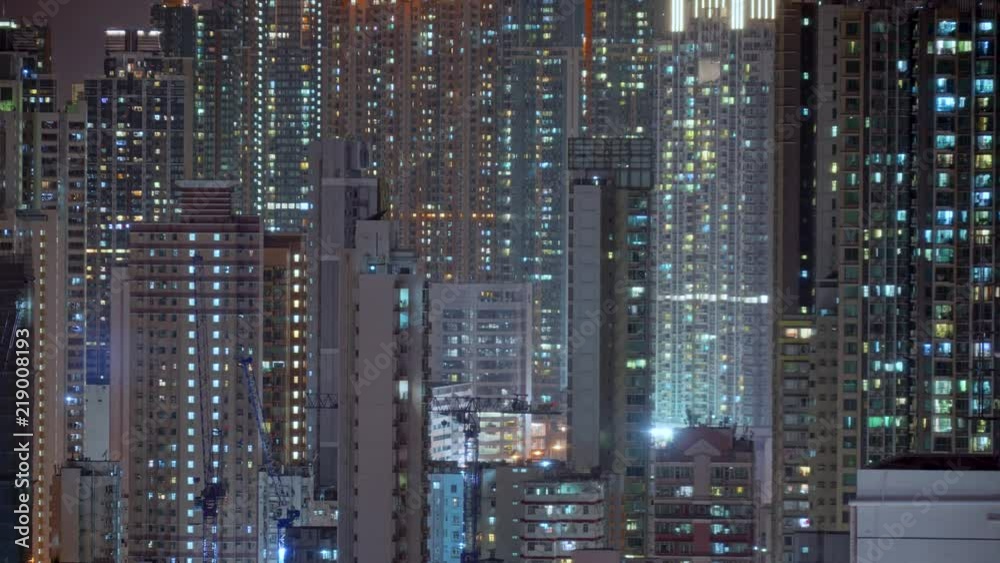 Wide day to night transition timelapse of Hong Kong apartments. Chinese crowded city with lights turning on and off at midnight. Fast paced modern Asian night-scape time lapse in urban metropolis. Wide day to night transition timelapse of Hong Kong apartments. Chinese crowded city with lights turning on and off at midnight. Fast paced modern Asian night-scape time lapse in urban metropolis.