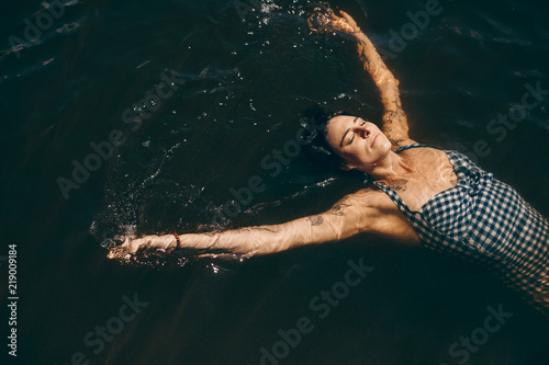 Woman swimming in a lake photo