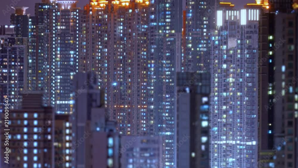 Loop of Hong Kong apartments at night.Chinese crowded city with lights turning on and off at midnight. Fast paced modern Asian night-scape time lapse in urban metropolis. Loop of Hong Kong apartments at night.Chinese crowded city with lights turning on and off at midnight. Fast paced modern Asian night-scape time lapse in urban metropolis.