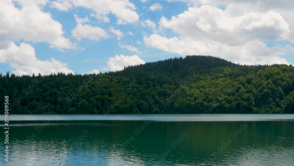 Beautiful view of a calm lake in front of a mountain during a sunny day at summer in Auvergne, France Beautiful view of a calm lake in front of a mountain during a sunny day at summer in Auvergne, France