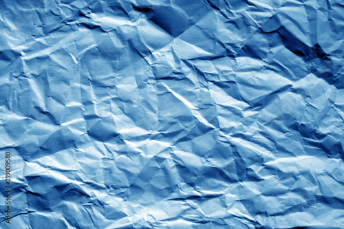 Crumpled sheet of paper in navy blue tone.