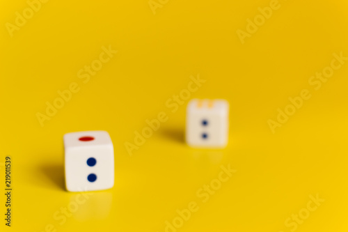 white dice on yellow background
