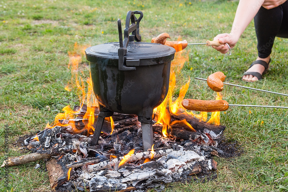 Baked potatoes in metallic cauldron. Traditional polish dish. Components: potatoes,sausage,carrot,onion,beetroot,bacon,salt and pepper.
