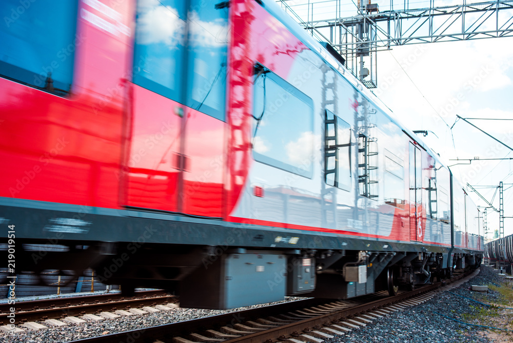 Modern high-speed train moves fast along the platform Modern high-speed train moves fast along the platform
