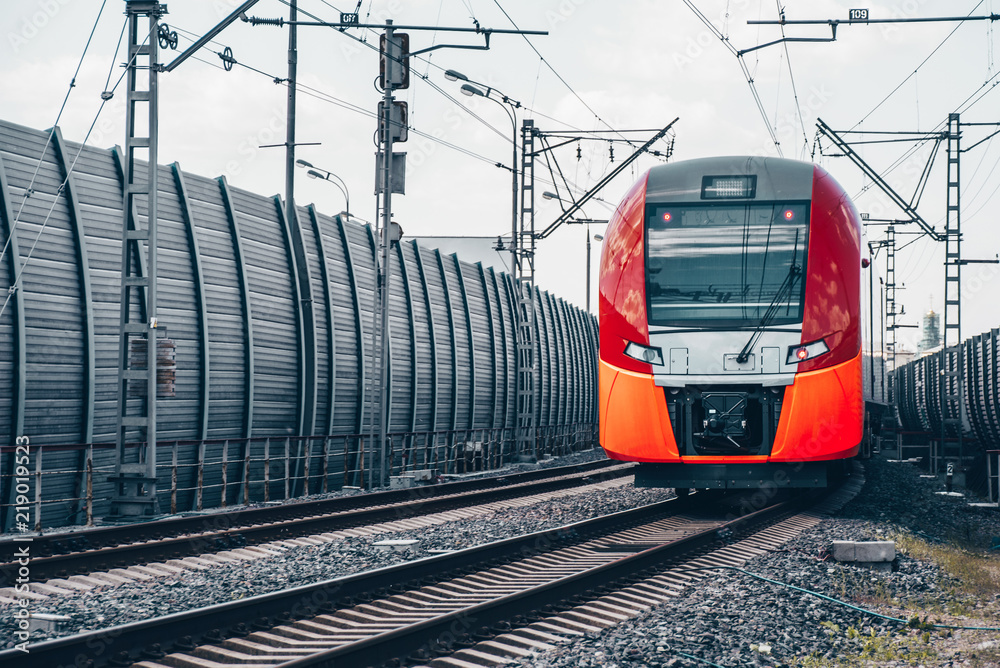 Modern high-speed train moves fast along the platform Modern high-speed train moves fast along the platform