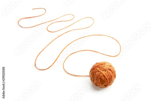 Orange thread ball with serpentine thread isolated on white background. Cotton thread ball. 