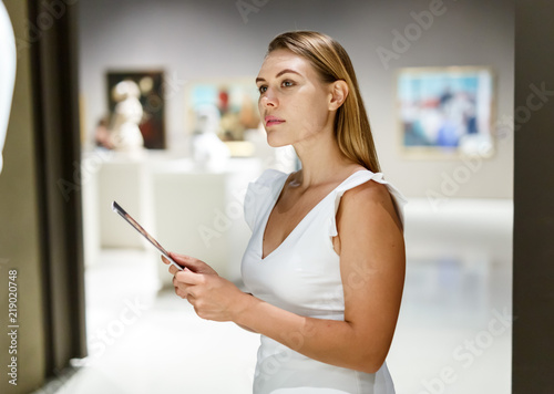 Woman observing museum exposition