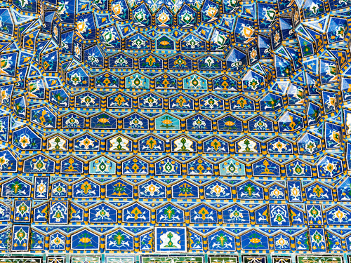 Geometric decoration of Islamic architecture. Detail of mosaic of ceramic tiles in Registan Square. Samarkand, Uzbekistan © maribom