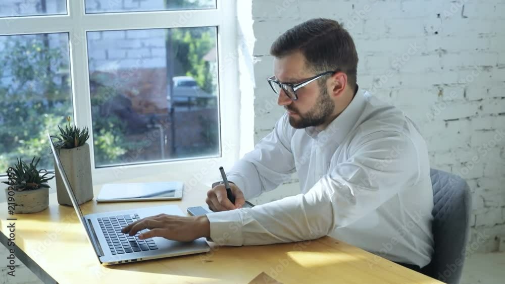 smiling caucasian bearded man using graphic tablet and notebook in office happy cheerful face male worker looking at screen hand drawing 3d animation production modeling design modern coworking studio smiling caucasian bearded man using graphic tablet and notebook in office happy cheerful face male worker looking at screen hand drawing 3d animation production modeling design modern coworking studio