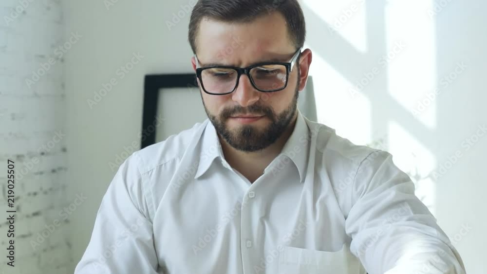 elegant brunette business man using laptop computer close notebook with calm face expression and thoughtful looking at window in sunny beautiful day modern office interior manager director worker elegant brunette business man using laptop computer close notebook with calm face expression and thoughtful looking at window in sunny beautiful day modern office interior manager director worker