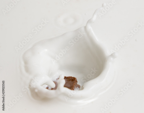 Chocolate falls in milk