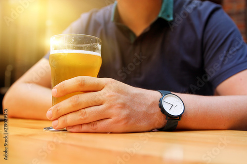 Young man drinking beer in the bar