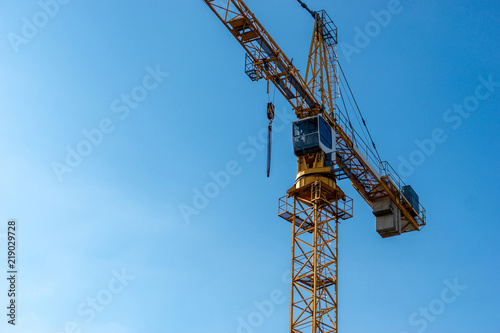 Wallpaper Mural orange crane with blue sky in the background - copy space on the left side Torontodigital.ca