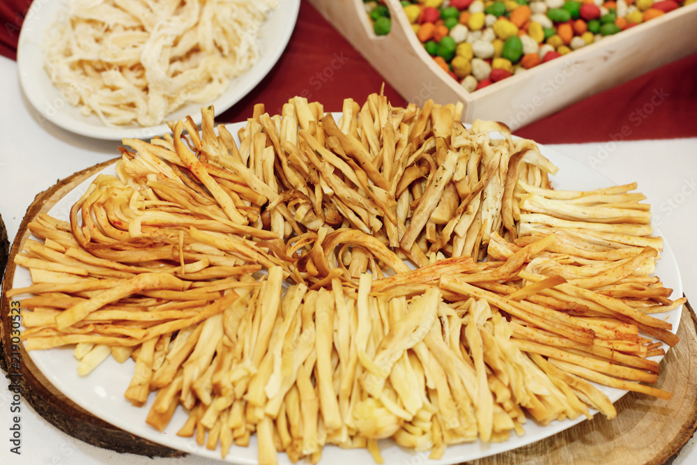 salty smoked cheese on wooden desk on table, wedding reception. beer bar and snacks. catering in restaurant salty smoked cheese on wooden desk on table, wedding reception. beer bar and snacks. catering in restaurant