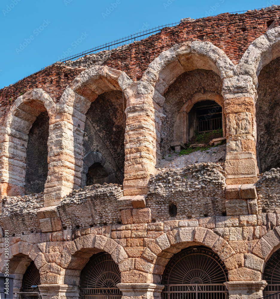 Side view of arches and details of famous ancient roman amphitheatre Arena di Verona, Italy, Europe. The amphitheater is on the square Bra
