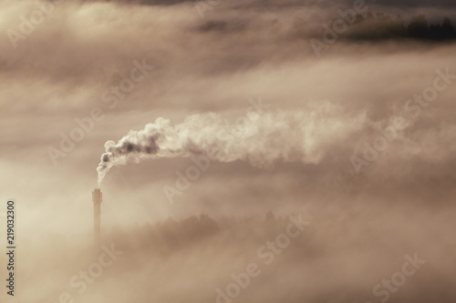 Mountain view over foggy landscape and chimney