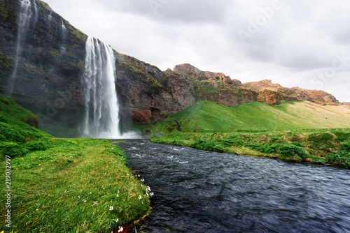 Sunrise on Seljalandfoss waterfall on Seljalandsa river  Iceland  Europe. Amazing view from inside