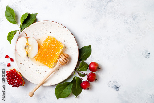 Apple, pomegranate and honey, traditional food of jewish New Year - Rosh Hashana. Copy space background photo