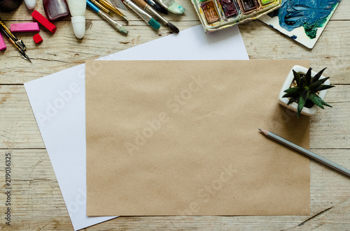 Creative artist workplace flat lay, mockup on wooden background