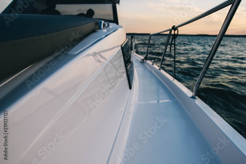 deck of a modern yacht in the sea at sunset. Travel by boat.
