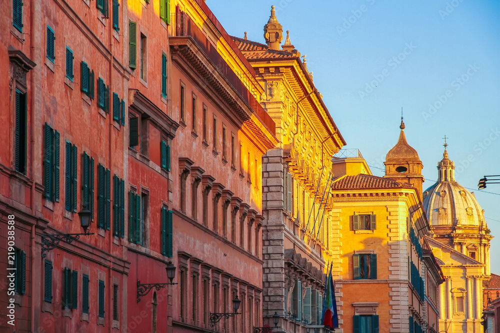 View on the ancient buildings and a historic church in Rome, Italy on a sunny day.