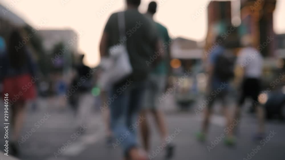 People cross the road at a traffic light, blurred background People cross the road at a traffic light, blurred background