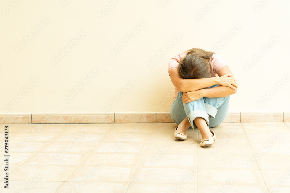 stressful depressed emotional person with anxiety disorder mental health illness sitting feeling bad with back against wall on the floor stressful depressed emotional person with anxiety disorder mental health illness sitting feeling bad with back against wall on the floor