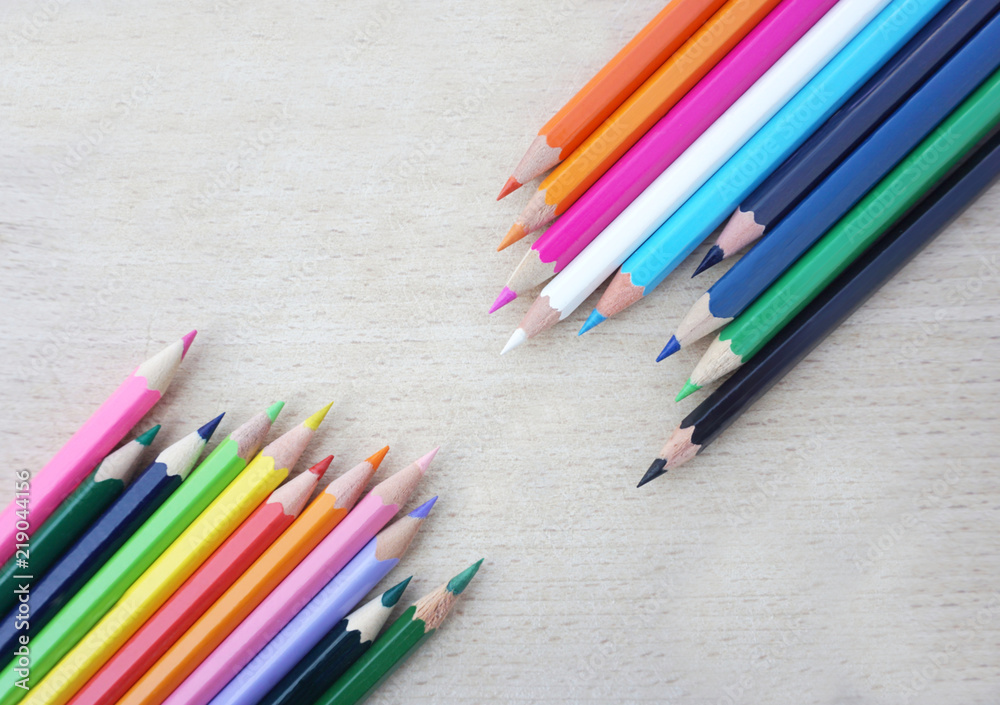 Wooden crayon in different color flat lay on wooden scratched background Wooden crayon in different color flat lay on wooden scratched background
