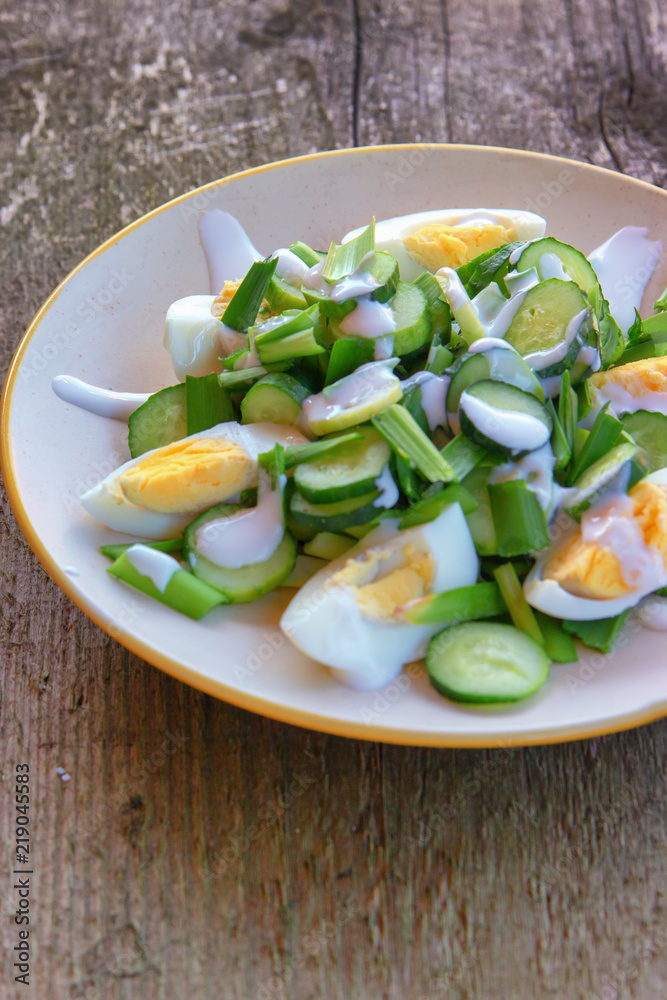 Dietary salad with chicken eggs, green onions, cucumbers and yogurt Dietary salad with chicken eggs, green onions, cucumbers and yogurt