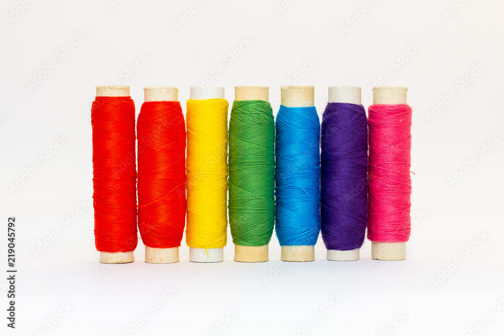 Standing colored thread coils on white background Standing colored thread coils on white background