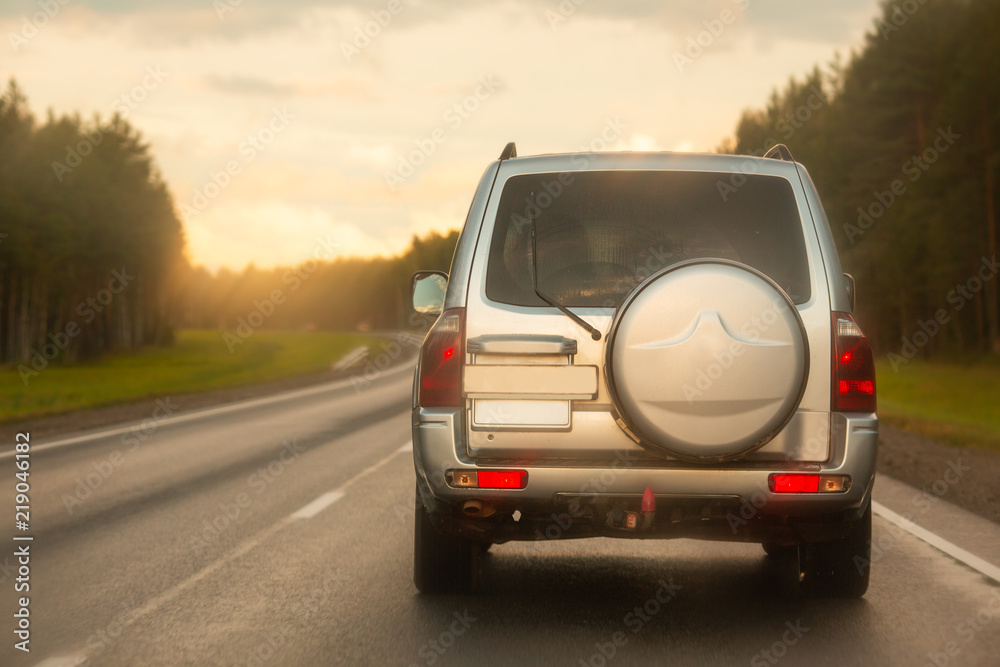 Car in traffic at sunset. Summer evening Car in traffic at sunset. Summer evening