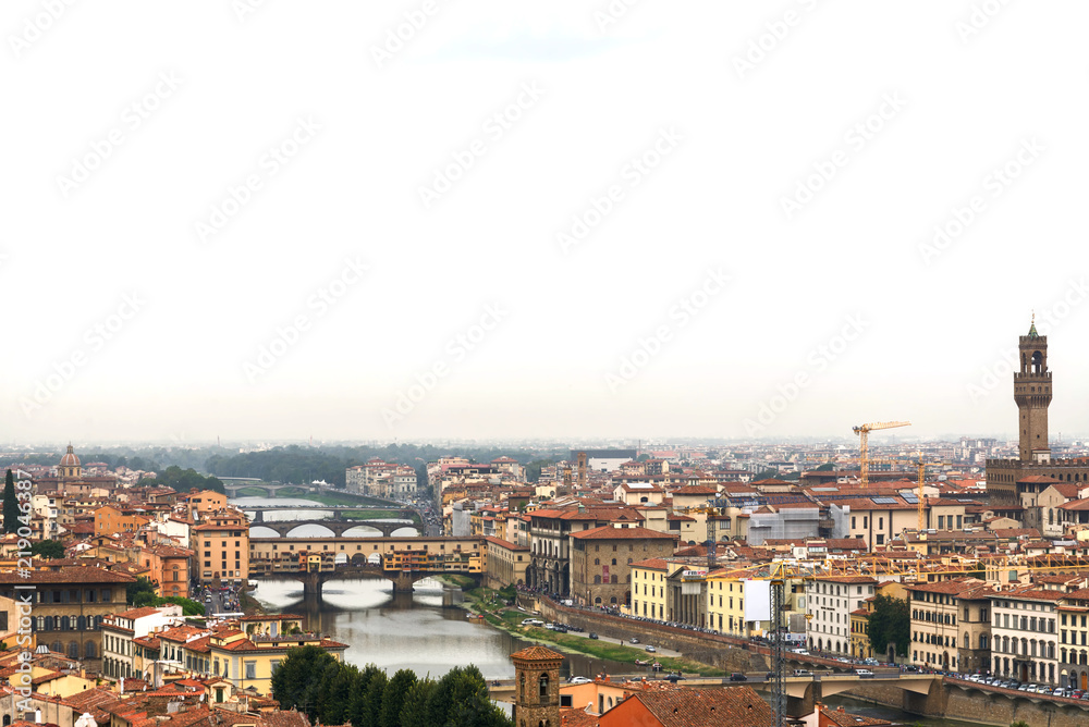 Top panoramic cityscape view of old town Florence city, Tuscany region, riverside of Arno river and Ponte vecchio bridge during raining and cloudy  from Piazzale Michelangelo in Florence, Italy