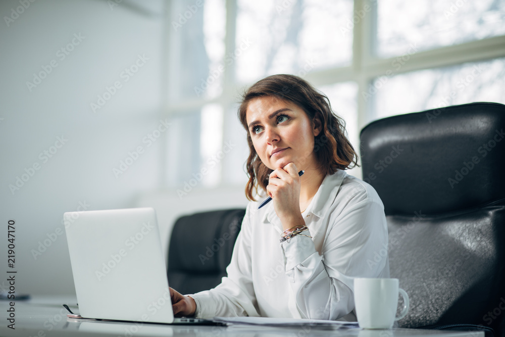 Young woman in office working Young woman in office working
