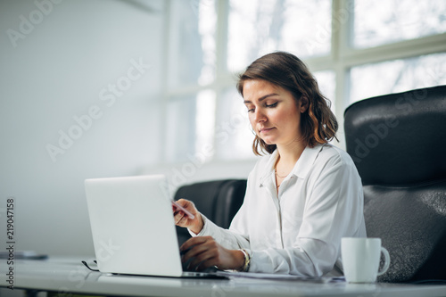 Young woman in office working