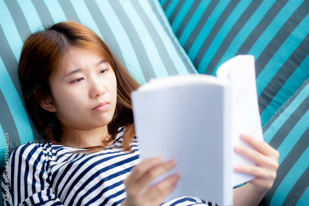 Beautiful of portrait young asian woman relax lying reading book on sofa in bedroom at home, girl study literature, education and lifestyle concept. Beautiful of portrait young asian woman relax lying reading book on sofa in bedroom at home, girl study literature, education and lifestyle concept.
