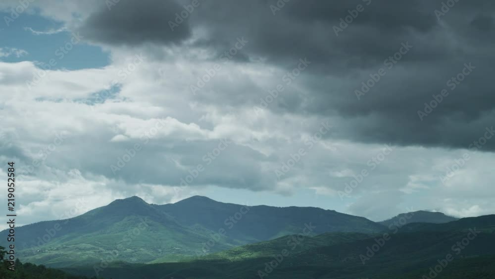 Time lapse of white clouds moving over mountains Time lapse of white clouds moving over mountains