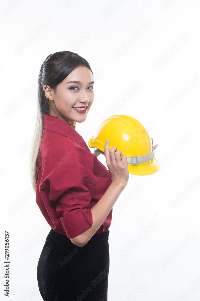 Beautiful engineering woman holding helmet with seriously face in red shirt and yellow helmet with white background, Beautiful engineering woman holding helmet with seriously face in red shirt and yellow helmet with white background,