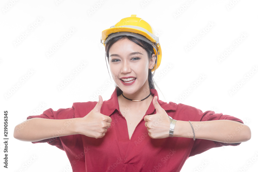 Engineering woman give a thump up in red shirt with yellow safety helmet in Studio light Engineering woman give a thump up in red shirt with yellow safety helmet in Studio light