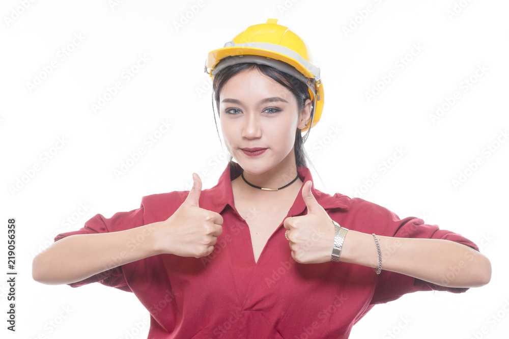 Engineering woman give a thump up in red shirt with yellow safety helmet in Studio light Engineering woman give a thump up in red shirt with yellow safety helmet in Studio light