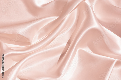 The texture of the satin fabric of pink color for the backgroundит