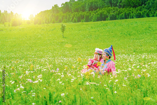 Mother and daughter dressed in Mongolian costumes on the grassland